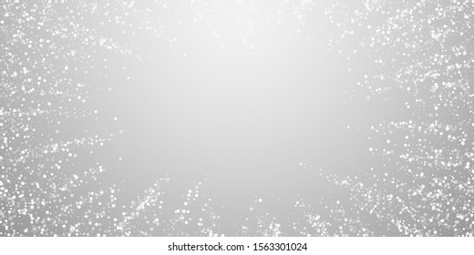 Random white dots Christmas background. Subtle flying snow flakes and stars on light grey background. Bewitching winter silver snowflake overlay template. Awesome vector illustration.