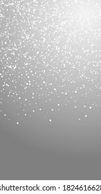 Random white dots Christmas background. Subtle flying snow flakes and stars on grey background. Appealing winter silver snowflake overlay template. Artistic vertical illustration.