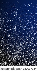 Random white dots Christmas background. Subtle flying snow flakes and stars on dark blue background. Appealing winter silver snowflake overlay template. Dramatic vertical illustration.