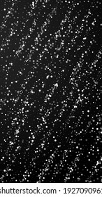 Random white dots Christmas background. Subtle flying snow flakes and stars on black background. Amazing winter silver snowflake overlay template. Captivating vertical illustration.
