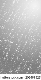 Random white dots Christmas background. Subtle flying snow flakes and stars on grey background. Amazing winter silver snowflake overlay template. Classic vertical illustration.