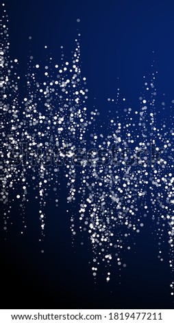 Random white dots Christmas background. Subtle flying snow flakes and stars on dark blue background. Alive winter silver snowflake overlay template. Stunning vertical illustration.