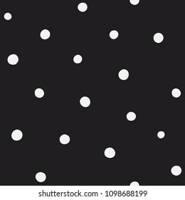 Randomly placed polka dots, hand drawn spots seamless vector pattern. Scattered big and small circles in various sizes. Monochrome abstract background. Decorative design elements in black and white.