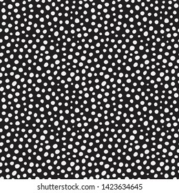 Randomly placed polka dots, hand drawn spots seamless vector pattern. Scattered big and small circles, points in various sizes. Monochrome retro background. Decorative black and white design tiles.
