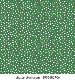 Randomly scattered white polka dots of various sizes and shapes on a green background. Abstract seamless vector  pattern for fabric, wallpaper, textile, wrapping. Dot background. Texture backdrop.