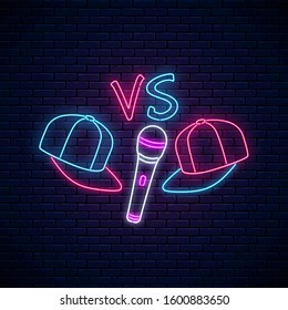 Rap battle neon sign with two baseball caps and microphone. Emblem of hip-hop music. Rap contest advertisement design. Bright banner, logo. Vector illustration.