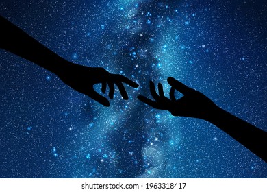 Reaching hands. Hand gesture silhouette. Night starry sky, Milky Way