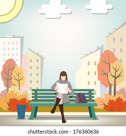 The reading woman on a bench in the fall