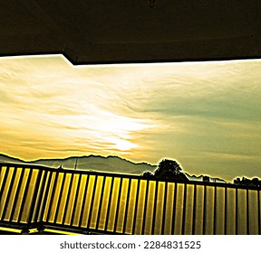 real background view of the sky in the afternoon.You can see the fence of tall buildings, sky, dusk, and mountains