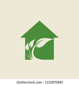 Real estate and ecological house vector icon.House shape with leaves branch logo.Modern, clean green sign isolated on light background.