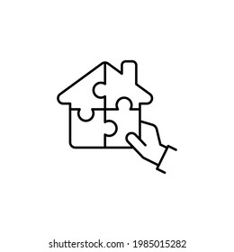 Real estate financing icon. Human hand solving house jigsaw puzzle. Line vector illustration isolated on white background.