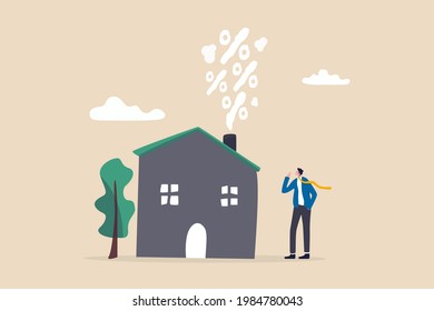 Real estate and housing mortgage rates, interest rate for house loan or renting, property tax or banking cost concept, businessman house owner looking at rising percentage smoke from house fireplace.