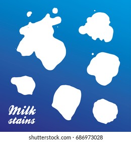 Real milk stains - set of silhouettes. Isolated on blue background. Vector. Eps 10