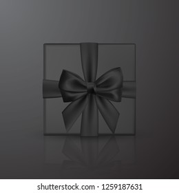 Realistic black gift box with black bow and ribbon. Element for decoration gifts, greetings, holidays. Vector illustration.