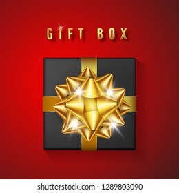 Realistic black gift box with golden bow and ribbon. Element for decoration gifts, greetings, holidays. Vector illustration.