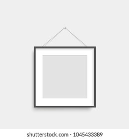 Realistic black photo frame hanging on th wall. Vector