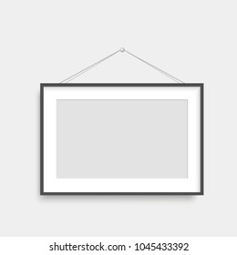 Realistic black photo frame hanging. Vector