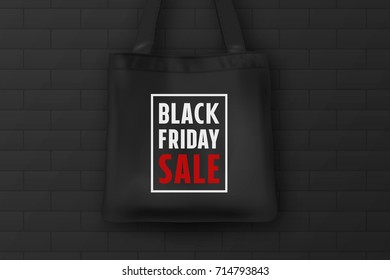 Realistic black textile tote bag with the inscription BLACK FRIDAY SALE. Closeup on brick black wall background. Design template for advertising, branding, mockup. Stock vector. EPS10.