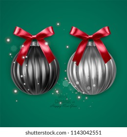 Realistic black and white christmas balls with red bow on green background, vector christmas decorations