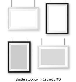 Realistic black and white picture frames with shadow. Hanging on a wall blank poster mockup. Empty photo frame. Vector illustration.