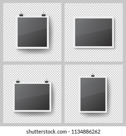 Realistic blank photo frames set on transparent background. Template picture frame hanging on binder clips. Isolated vector framework with shadow on the wall. Black empty place for presentation