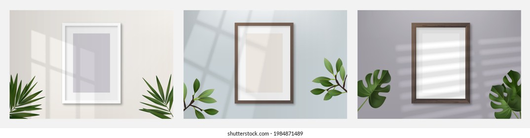 Realistic blank picture frame  hanging on a light wall from the Front with overlay shadows and tropical plants. Design Template for Mock Up.