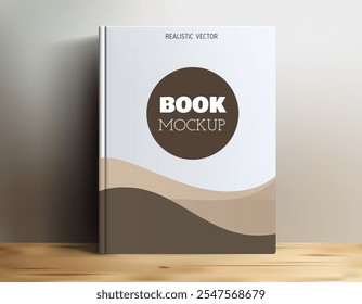 Uma maquete de livro realista exibida em uma superfície de madeira, apresentando um design simples com uma área de título circular rotulada 'BOOK MOCKUP'. O plano de fundo tem curvas suaves em cores neutras.