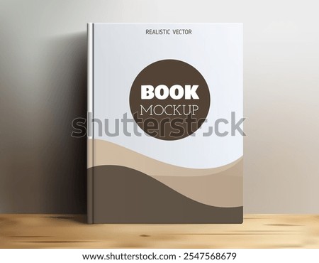 A realistic book mockup displayed on a wooden surface, featuring a simple design with a circular title area labeled 'BOOK MOCKUP'. The background has soft curves in neutral colors.