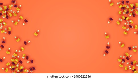 Realistic candy corn on isolated orange background with empty copy space. Halloween season concept for october autumn event.