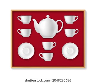 Realistic ceramic tea set, tea cups, pot, mugs and porcelains. Vector 3d white colored crockery teapot, cups and saucers for drinking hot beverage lying in wood box with red velvet sheathing top view