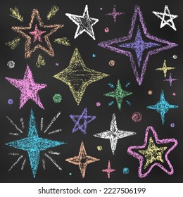 Realistic Chalk Drawn Sketch. Set of Design Elements Stars of Different Colors Isolated on Chalkboard Backdrop. Kit of Textural Crayon Drawings of Night Sky Symbols on Blackboard.