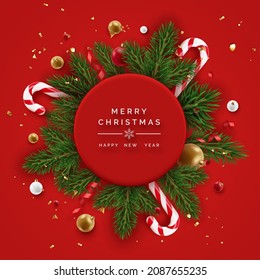 Realistic Christmas decor with pine branches, confetti, candy canes, golden and red balls. Christmas concept. New year vector card on red background