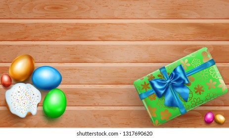 Realistic colored Easter eggs, tasty cake and beautiful gift box with bow on wooden planks