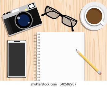 Realistic creative workplace elements in top view. working space on wooden table. notebook with empty space. blank paper note with pencil, retro camera, glasses, smart phone and coffee cup on desk