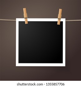 Realistic detailed photo icon design template. Photo frame hanging on the rope with clothespines