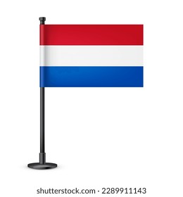 Realistic Dutch table flag on a black steel pole. Souvenir from Netherlands. Desk flag made of paper or fabric and shiny metal stand. Mockup for promotion and advertising. Vector illustration