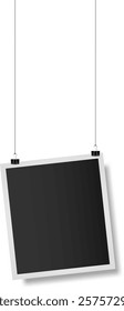 Realistic empty photo frame hanging on strings with binder clips against a white background, serving as a vintage mockup for retro snapshots and scrapbook designs