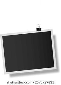 Realistic empty photo frame hanging on a string with a binder clip, isolated against a clean white background, perfect for inserting images or designs in various creative projects