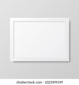 Realistic empty white picture frame, isolated on a neutral gray background. 