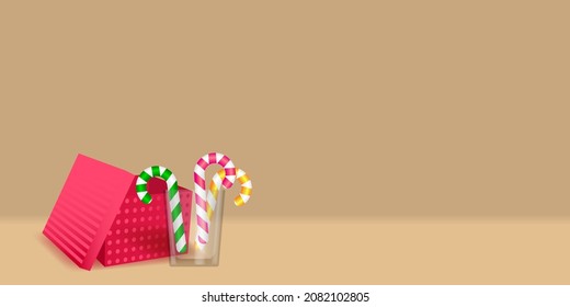 Realistic festive scene. Open gift box and candy canes in transparent glass.  Merry Christmas and Happy New Year background with 3d decor