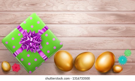 Realistic golden Easter eggs and beautiful gift box with bow on wooden planks