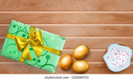 Realistic golden Easter eggs, tasty cake and beautiful gift box with bow on wooden planks