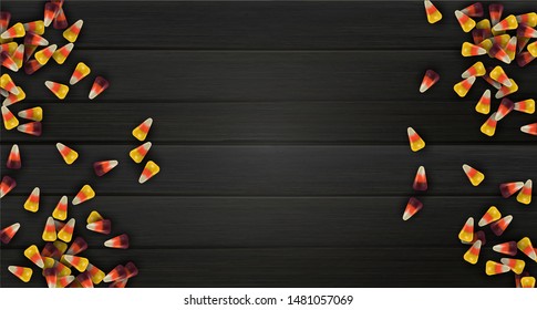 Realistic halloween background concept, colorful 3d candy corn on black wood surface. Top view children treats with copy space.