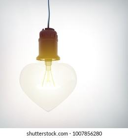 Realistic hanging glowing lightbulb romantic concept in heart shape on gray background isolated vector illustration
