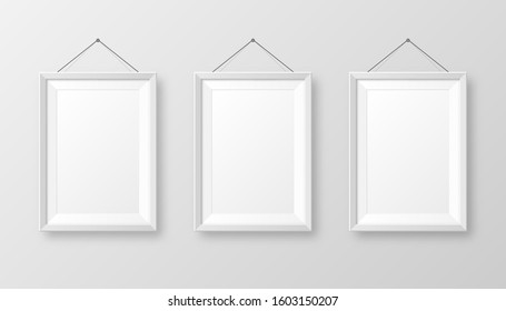 Realistic hanging on a wall blank white picture frame with shadow. Modern poster mockup isolated on gray background. Empty photo frame for art gallery or interior. Vector illustration.