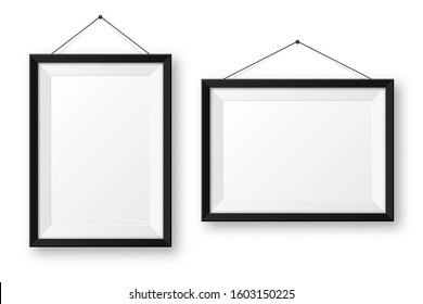 Realistic hanging on a wall blank black picture frame with shadow. Modern poster mockup isolated on white background. Empty photo frame for art gallery or interior. Vector illustration.