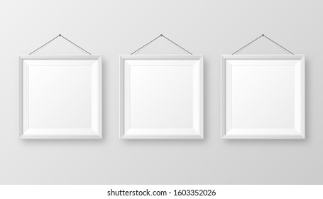 Realistic hanging on a wall blank white picture frame with shadow. Modern poster mockup isolated on gray background. Empty photo frame for art gallery or interior. Vector illustration.