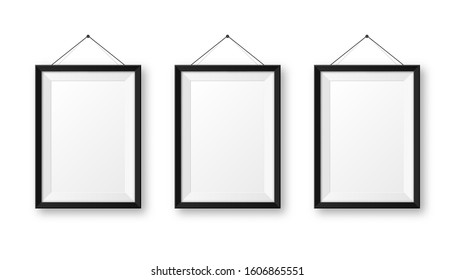 Realistic hanging on a wall blank black picture frame with shadow. Modern poster mockup isolated on white background. Empty photo frame for art gallery or interior. Vector illustration.