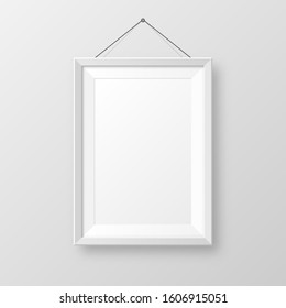 Realistic hanging on a wall blank white picture frame with shadow. Modern poster mockup isolated on gray background. Empty photo frame for art gallery or interior. Vector illustration.