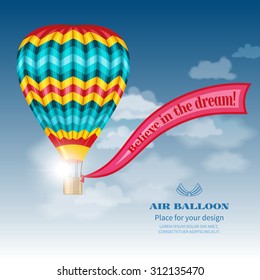 Realistic hot air balloon with ribbon on background of sky and clouds